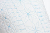 detail of cream machine quilted cushion with blue thread
