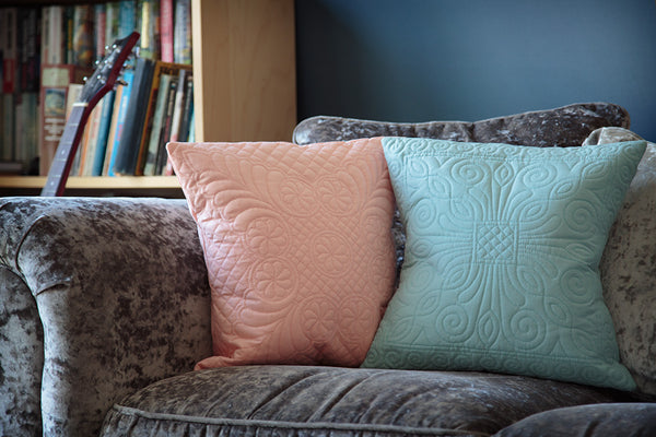 Our Durham and Welsh Wholecloth cushions on a plush sofa