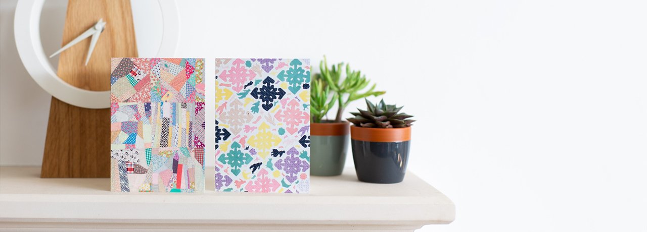 twopatchwork notecards on a cream mantle piece with a modern clock and two small succulent plants